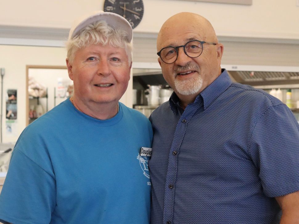 Two men smiling at the camera